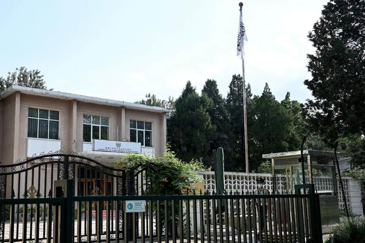 A Chinese paramilitary police stands guard outside the Afghanistan Embassy, with a Taliban flag displayed in the compound, in Beijing on Aug. 16, 2022. (Noel Celis/AFP via Getty Images)
