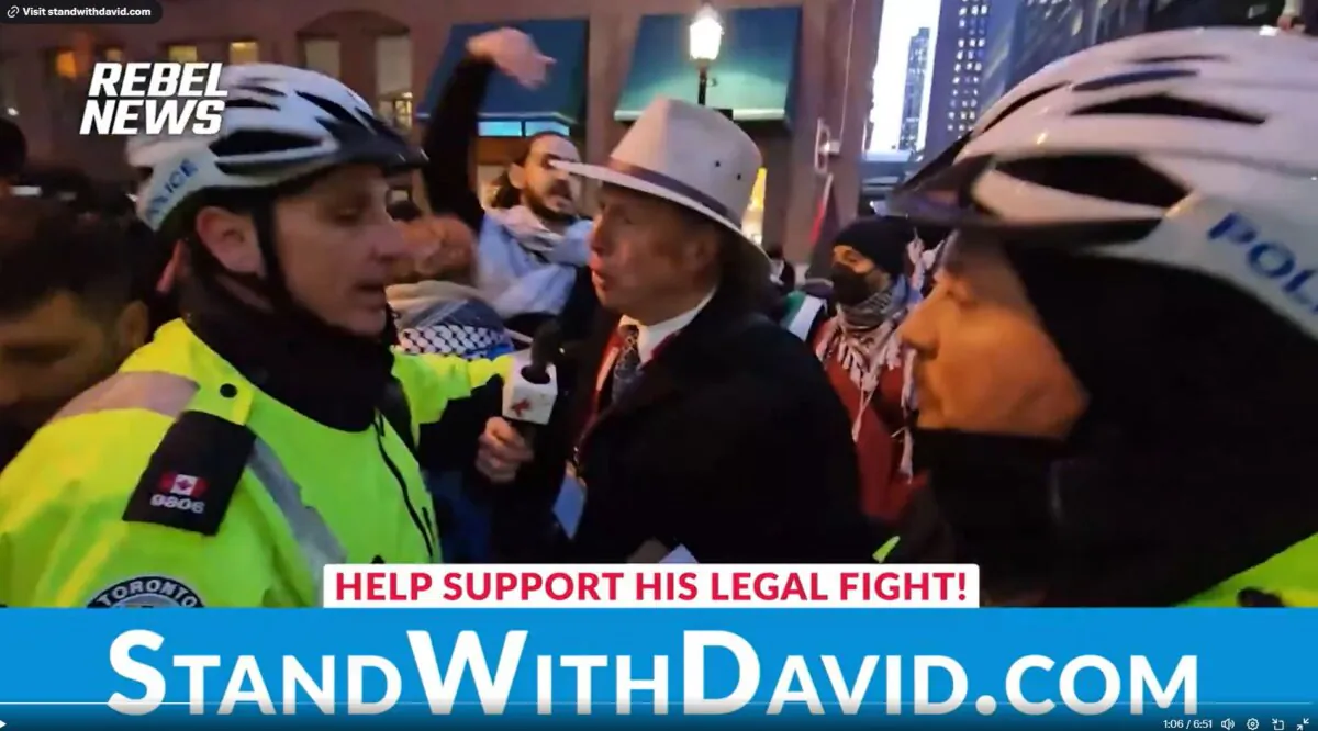 Rebel News reporter David Menzies is taken away by police after he attempted to talk to some of the pro-Palestine protesters in Toronto on March 15, 2024. (Courtesy of Rebel News)