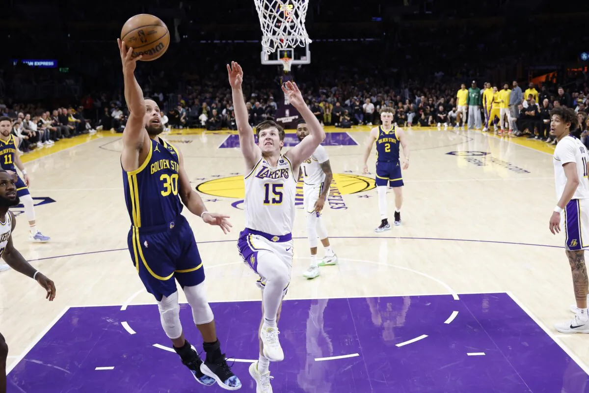 Stephen Curry (30) of the Golden State Warriors shoots past the defense of Austin Reaves (15) of the Los Angeles Lakers during the second half of a game in Los Angeles on March 16, 2024. (Sean M. Haffey/Getty Images)