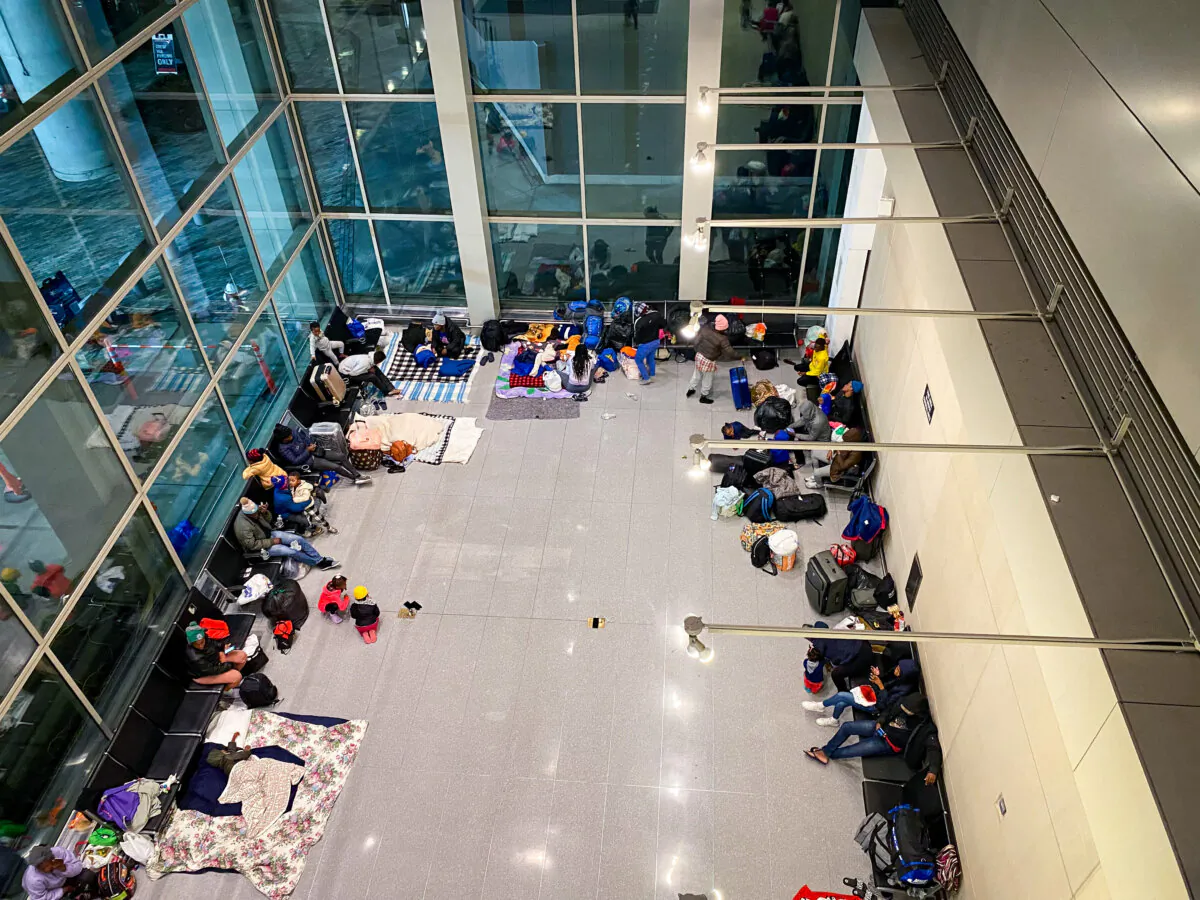 At least 100 illegal immigrants sheltering in a public wing at Boston's Logan Airport on Jan. 25, 2024. (Alice Giordano/The Epoch Times)