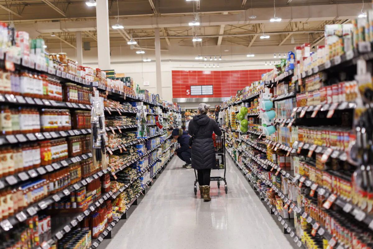 A customer browses the shelves down an aisle at a Metro grocery store In Toronto on Feb. 2, 2024. (The Canadian Press/Cole Burston)
