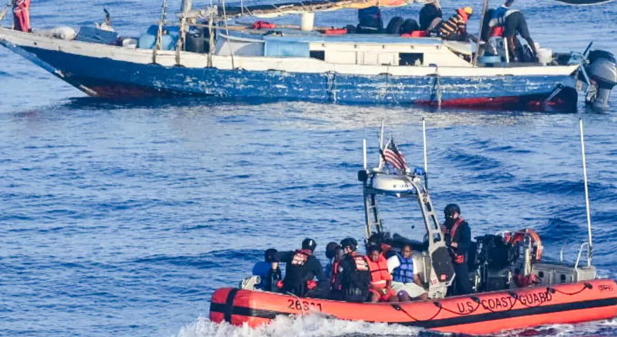 A small boat crew assigned to U.S. Coast Guard Cutter Venturous' ferries Haitians to the cutter, approximately 17 miles northeast of Punta Maisi, Cuba, on April 9, 2022. (U.S. Coast Guard photo by Coast Guard Cutter Venturous)