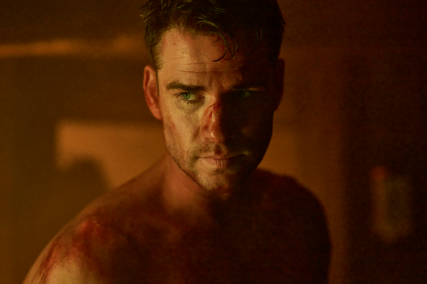 man with bloody cuts and no shirt in LAND OF BAD