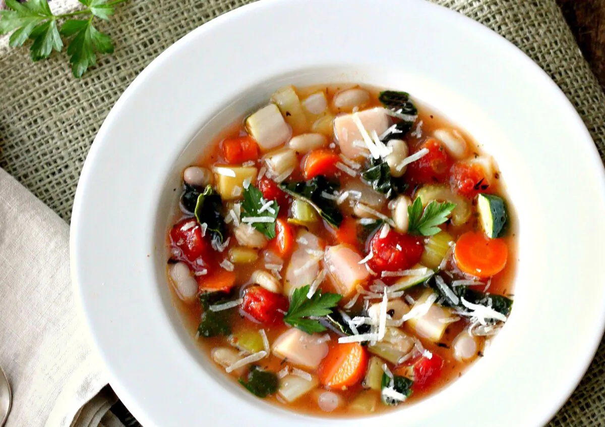 A bright tomato-based broth and hearty white beans are staples of this adaptable recipe. (Lynda Balslev for Tastefood)