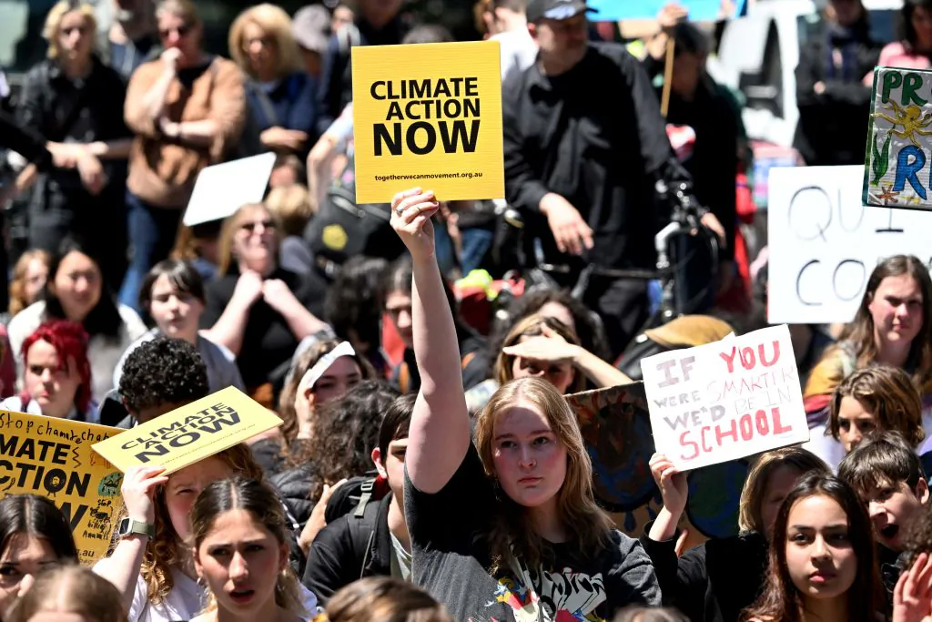 School students hold up placards as they march at a School Strike 4 Climate rally calling for climate action in Melbourne on Nov. 17, 2023. (William West/AFP via Getty Images)