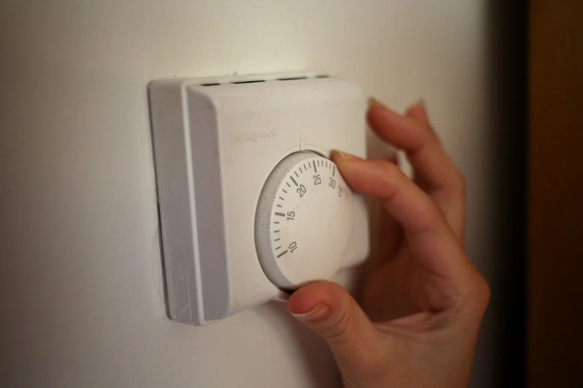 A person using a central heating thermostat in the United Kingdom in a file photo. (Steve Parsons/PA Wire)