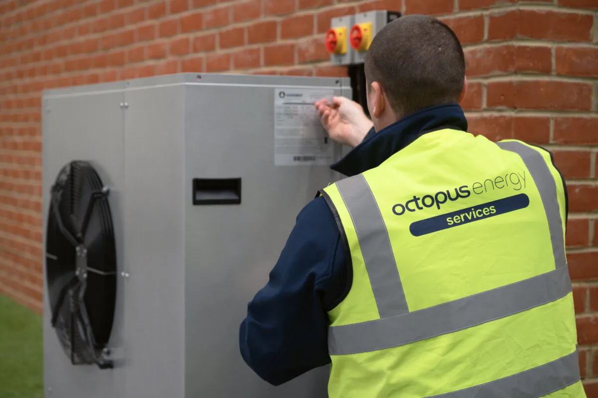 An engineer checks the installation of a Daikin 7KW heat pump on a model house within the Octopus Energy training facility in Slough, England, on Nov. 2, 2021. (Leon Neal/Getty Images)