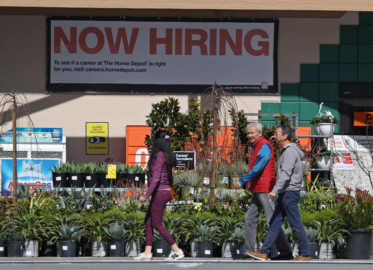 Home Depot customers walk by a Now Hiring sign in San Rafael, Calif., on March 8, 2024. (Justin Sullivan/Getty Images)