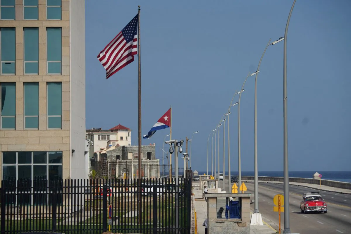 A vintage car passes by the U.S. Embassy in Havana on June 15, 2022. (Alexandre Meneghini/Reuters)