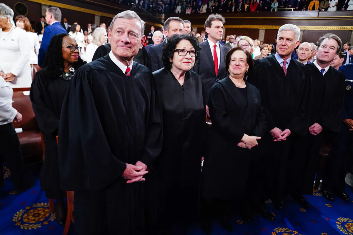 Chief Justice of the Supreme Court John Roberts (L) along with (L–R) Associate Justices Sonia Sotomayor, Elena Kagan, Neil Gorsuch, Brett Kavanaugh, and Ketanji Brown Jackson (back) stand in the House of Representatives ahead of President Joe Biden's third State of the Union address to a joint session of Congress in the House Chamber of the U.S. Capitol on March 7, 2024. (Shawn Thew/Pool/AFP via Getty Images)