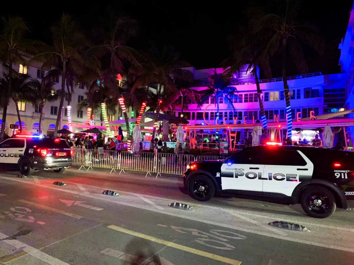 Miami Beach Police cars drive passed The Clevelander Hotel and Club in Miami Beach, Fla., on March 14, 2024. (T.J. Muscaro/The Epoch Times)