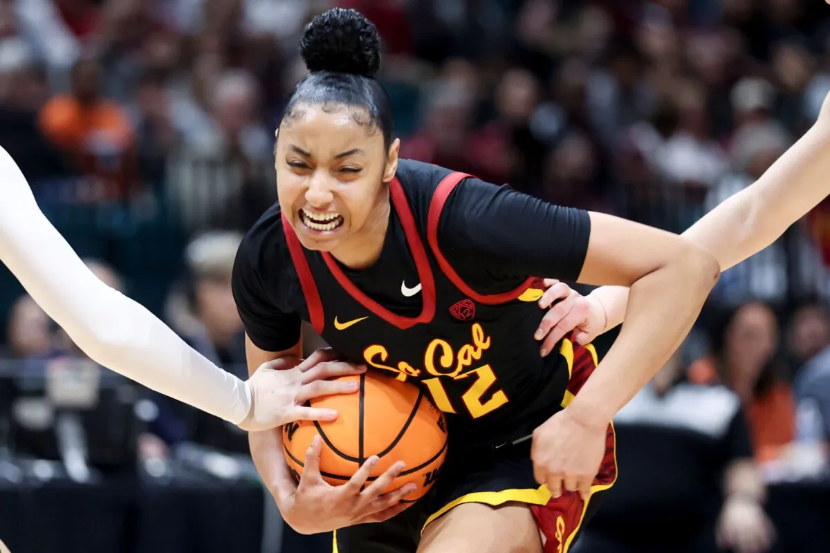 USC guard JuJu Watkins reacts while driving past two Stanford defenders in the Pacific-12 Conference championship game
in Las Vegas on March 10, 2024. (Ian Maule/AP Photo)