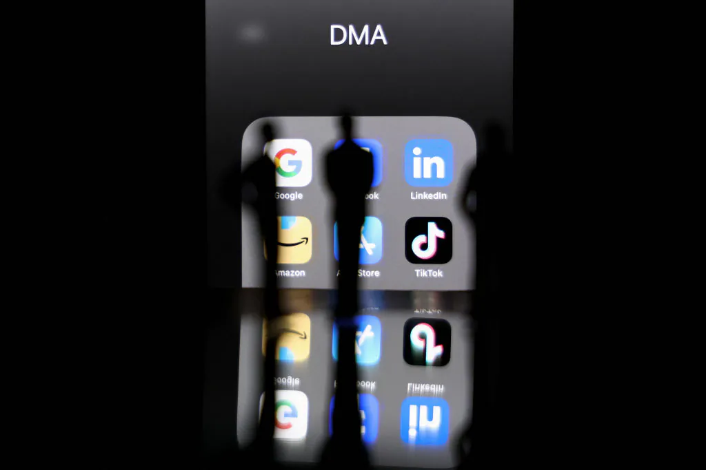 This photo taken on Feb. 12, 2023, in Brussels shows reflexions on a smartphone screen of logos of online platforms google, Facebook, LinkedIn, Amazon, Apple store, and TikTok. (KENZO TRIBOUILLARD/AFP via Getty Images)