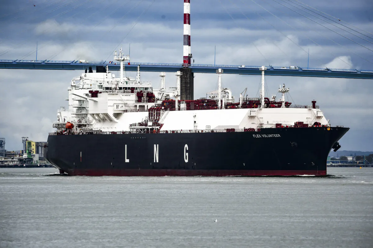 The LNG (liquefied natural gas) tanker Flex Volunteer, sailing under the flag of the Marshall Islands, cruises near the Saint-Nazaire bridge over the Loire estuary, as it leaves the dock of the LNG Terminal of Montoir-de-Bretagne, near Saint-Nazaire, western France, on April 12, 2022. (Sebastien Salom-Gomis/AFP via Getty Images)