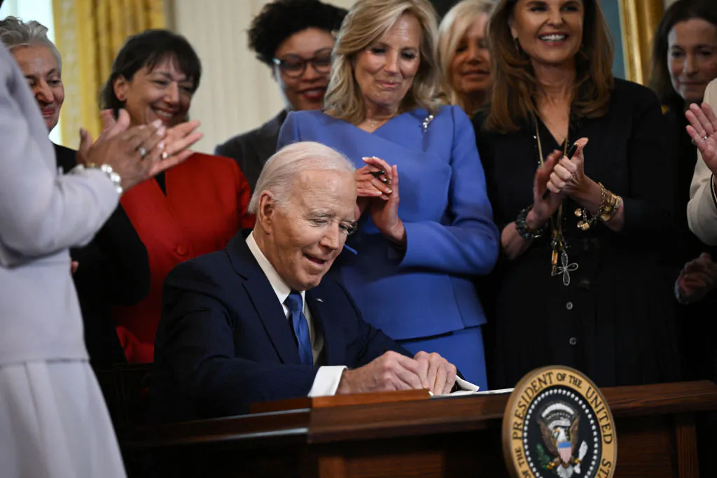 President Joe Biden signs an executive order aimed at advancing the study of women's health during a reception honoring Women's History Month in the East Room of the White House in Washington, on March 18, 2024. (Brendan Smialowski/AFP via Getty Images)