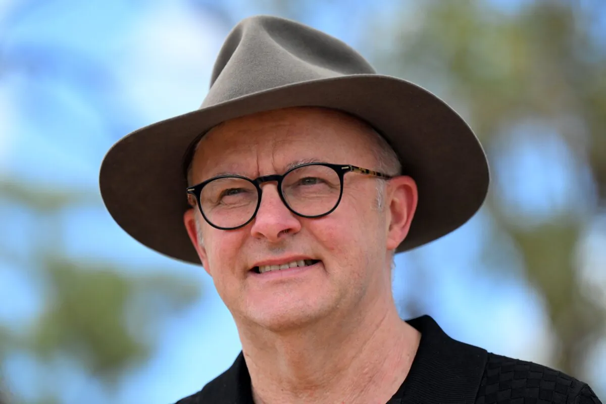 Australian Prime Minister Anthony Albanese speaks to locals after touring a newly built community housing unit at Binjari near Katherine, Northern Territory on March 12, 2024. (AAP Image/Lukas Coch) 