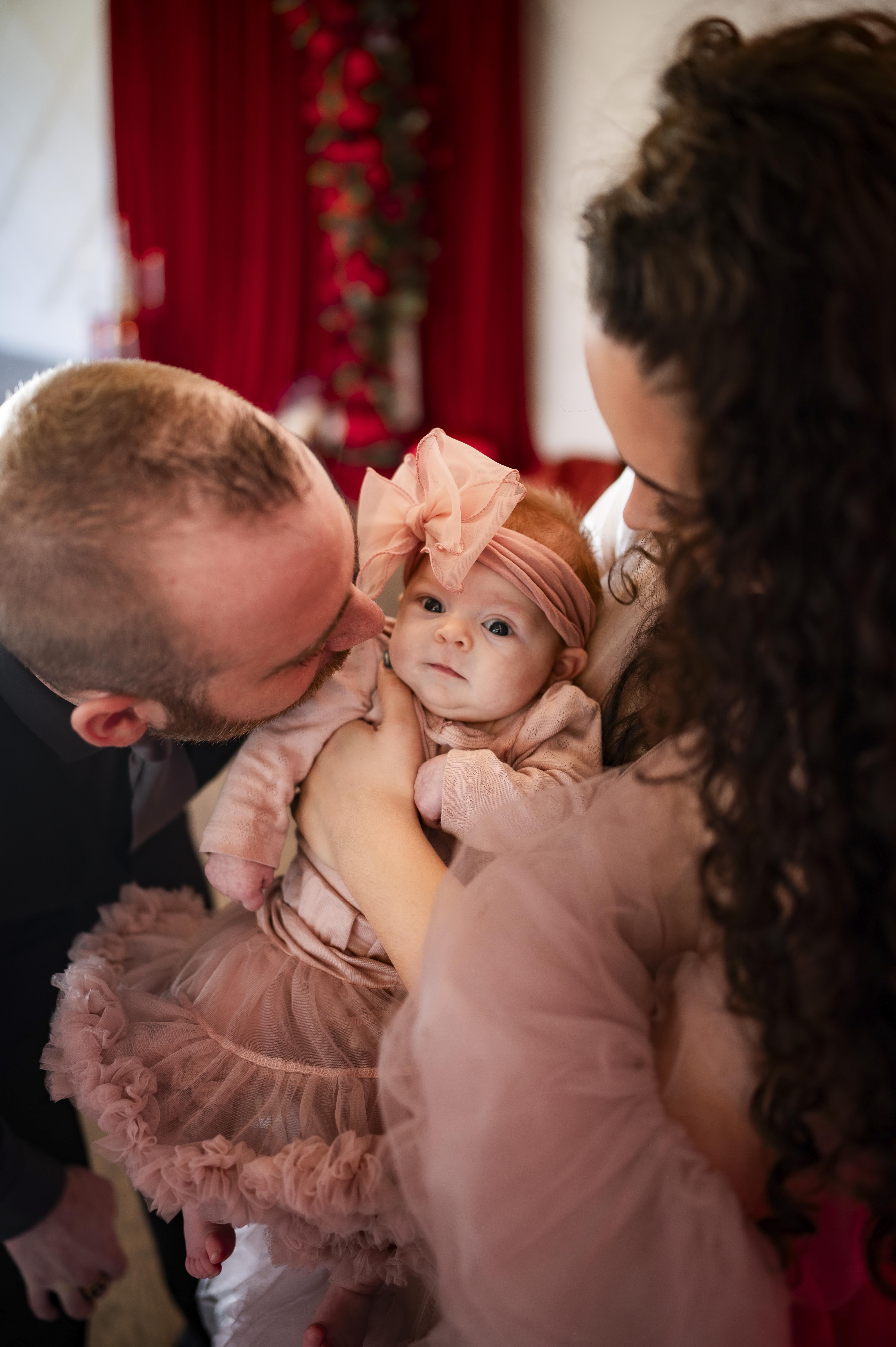 Mr. and Ms. Caminiti with their newborn daughter.