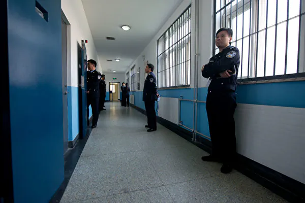 Police guards stand in a hallway inside the No.1 Detention Center during a government-guided tour in Beijing on Oct. 25, 2012. (Ed Jones/AFP via Getty Images)