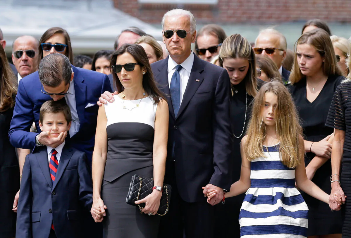 On June 6, 2015, Hunter Biden (L) kisses his nephew Hunter, son of Beau Biden, as they stand with Beau's widow Hallie (3L), then-Vice President Joe Biden and Beau's daughter Natalie before his funeral, at St. Anthony of Padua Roman Catholic Church in Wilmington, Del. (AP Photo/Patrick Semansky)