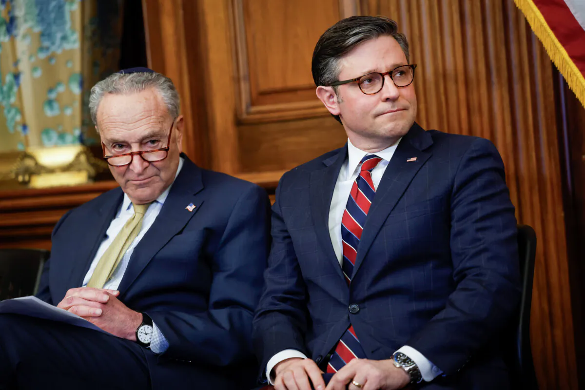 Senate Majority Leader Chuck Schumer (D-N.Y.) and House Speaker Mike Johnson (R-La.) listen during remarks at a Capitol Menorah lighting ceremony at the U.S. Capitol Building in Washington on Dec. 12, 2023. (Anna Moneymaker/Getty Images)