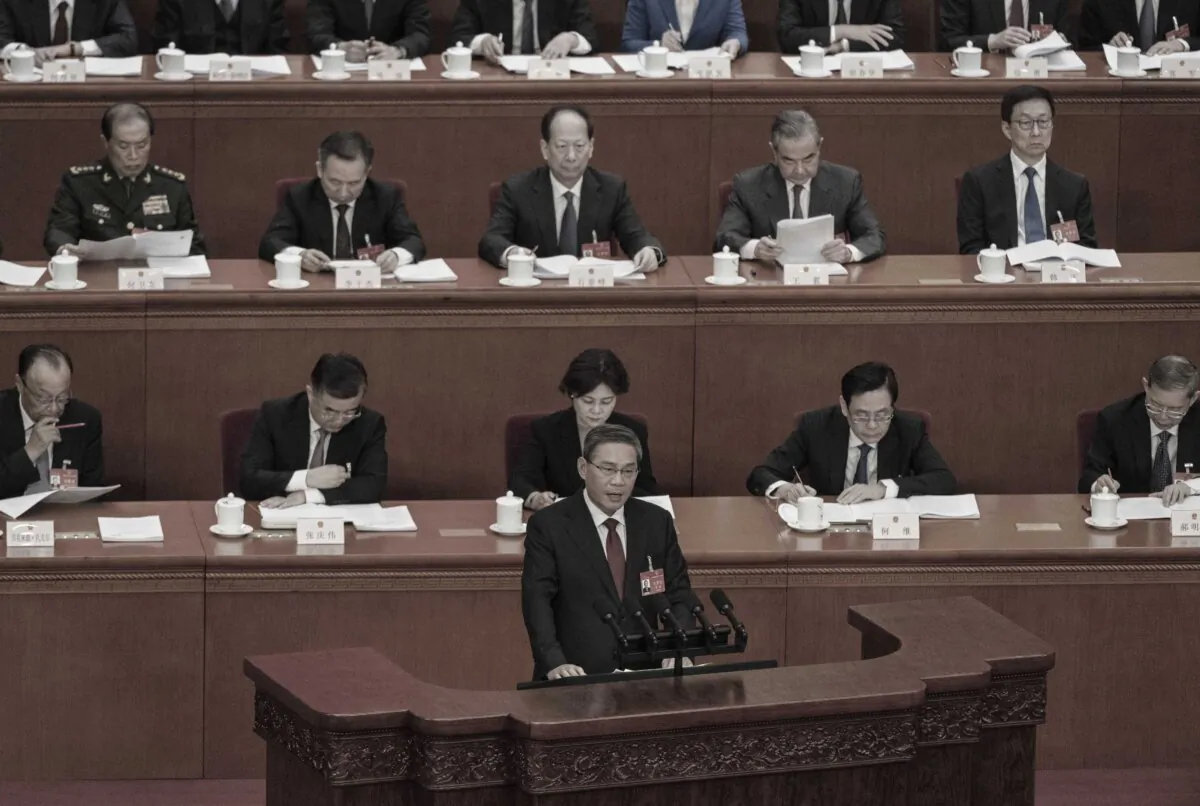 Chinese Premier Li Qiang (C) speaks from the podium during his speech at the opening of the NPC, or National People's Congress, in Beijing on March 5, 2024. (Kevin Frayer/Getty Images)