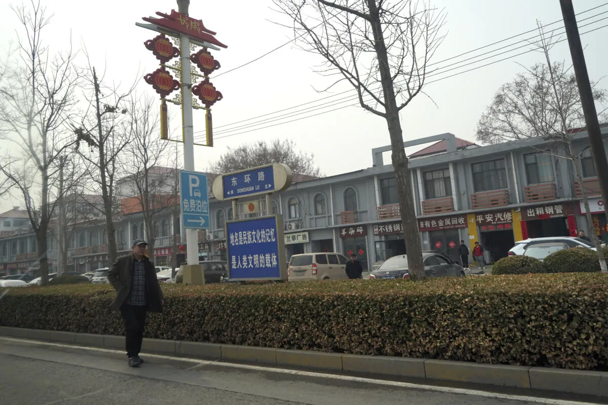 A man walks along the road in the city of Handan in northern China's Hebei province on Feb. 28, 2024. (Emily Wang Fujiyama/AP Photo)