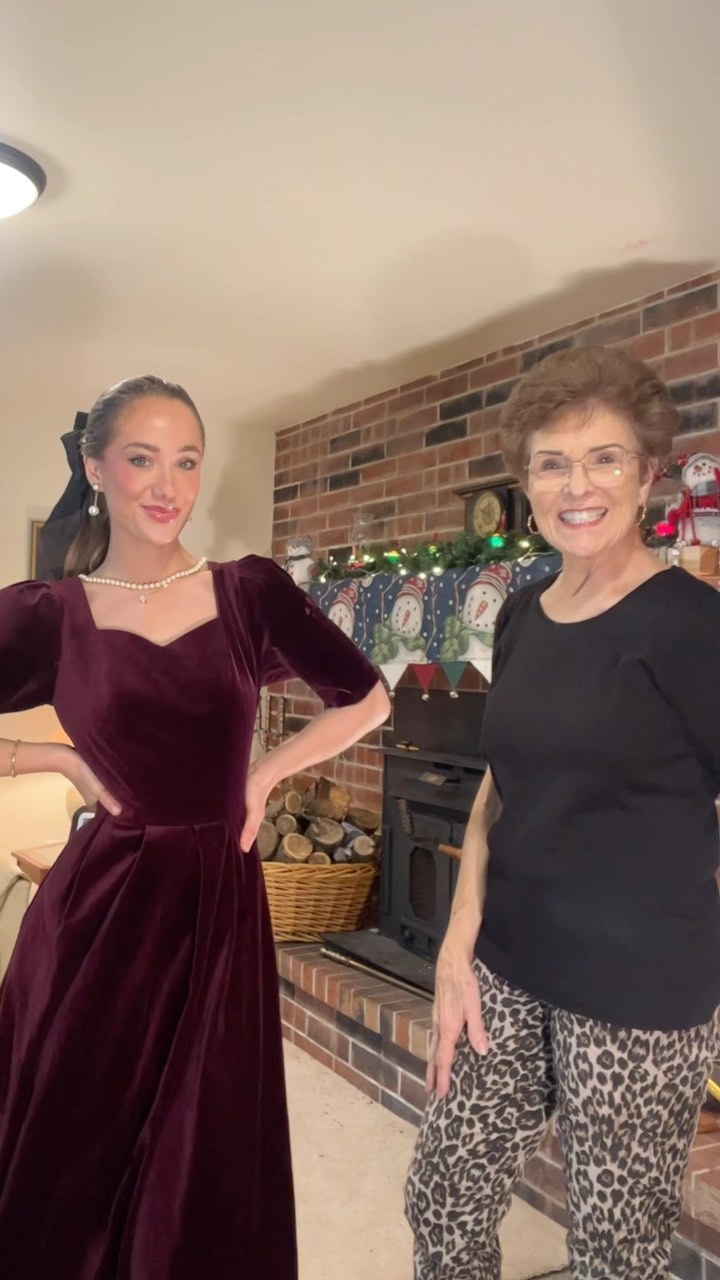Ms. Jan wears a velvet dress with her sweetheart neckline.