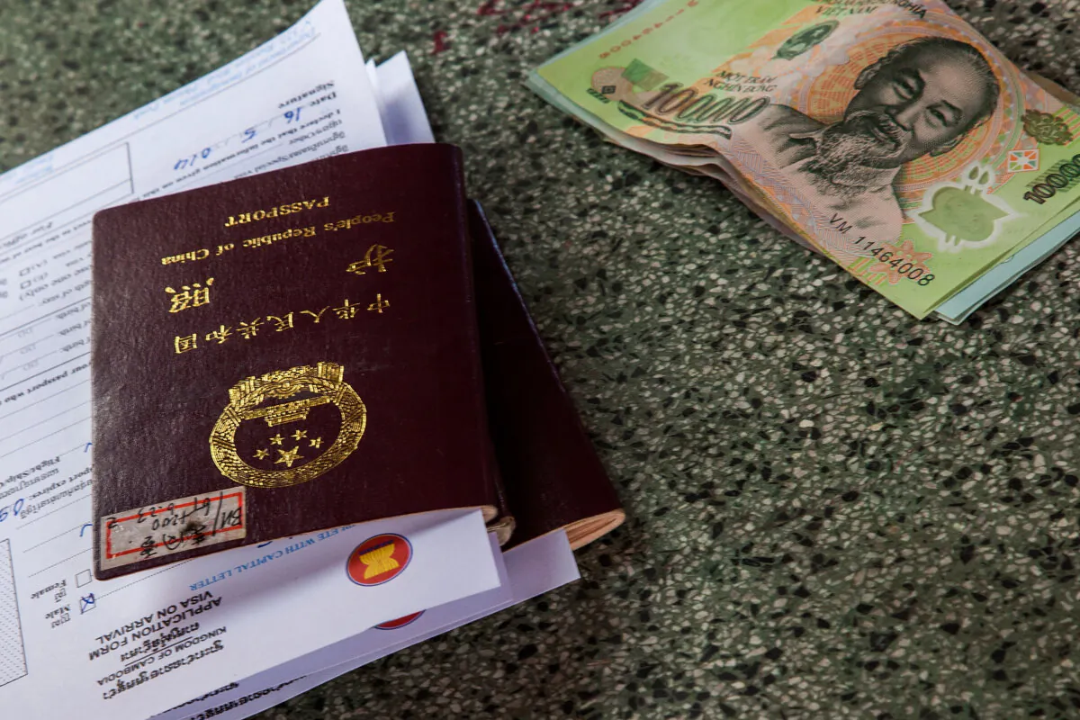 A Chinese passport and some Vietnamese Dongs are left on one of the tables of the customs office for a Cambodian visa application on May 16, 2014 at the Bavet border crossing, Cambodia. (Omar Havana/Getty Images)