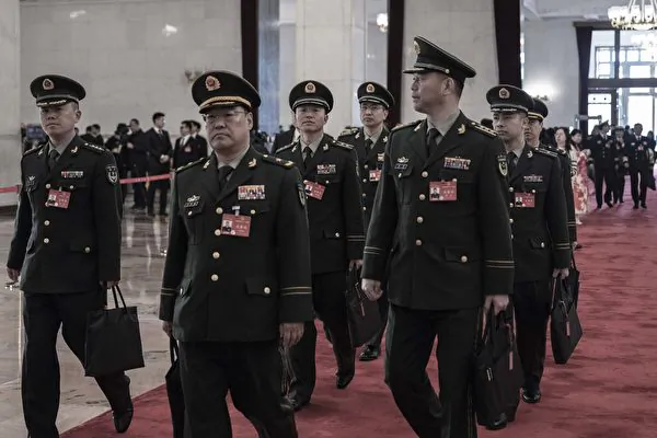 BEIJING, CHINA - MARCH 8: Chinese military delegates arrive at the second plenary session of the National Peoples Congress at the Great Hall of the People on March 8, 2024 in Beijing, China. China's annual political gathering known as the Two Sessions convenes leaders and lawmakers to set the government's agenda for domestic economic and social development for the year. (Photo by Kevin Frayer/Getty Images)