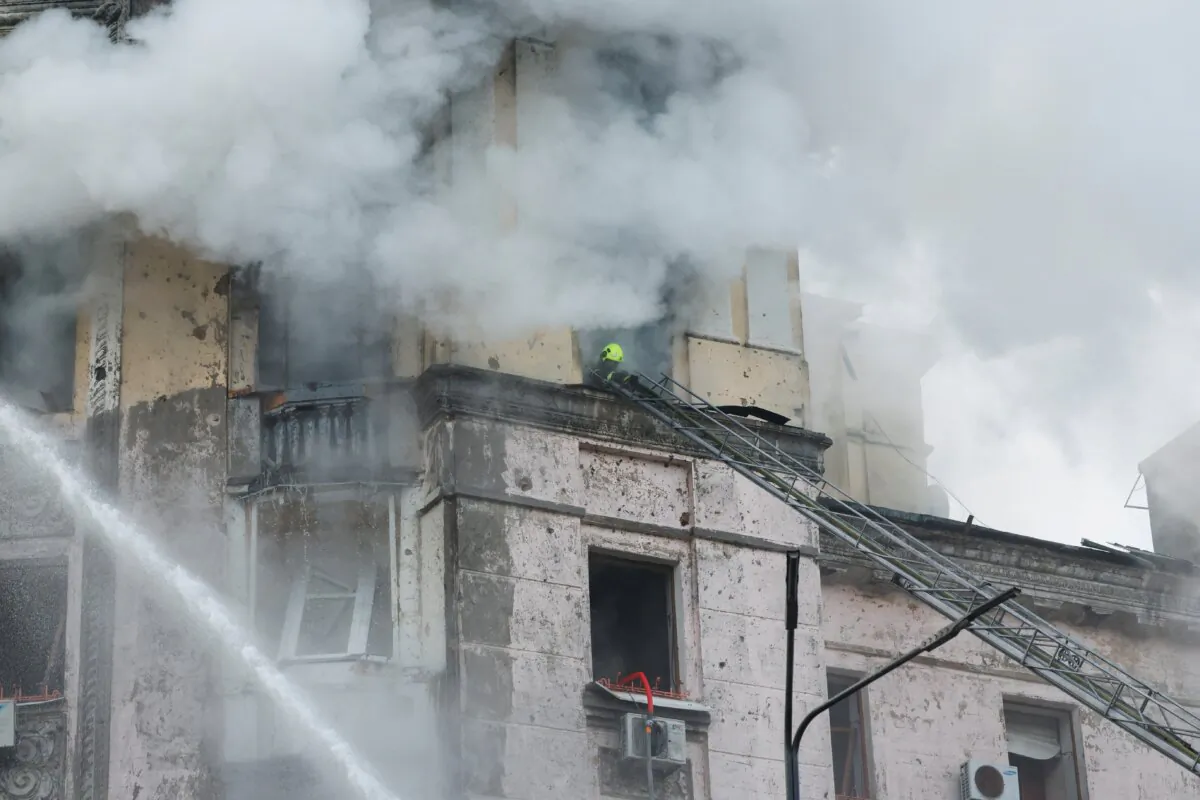 A rescuer works at a site of a building damaged during a Russian missile strike, in Kyiv, Ukraine, on March 21, 2024. (Alina Smutko/Reuters)
