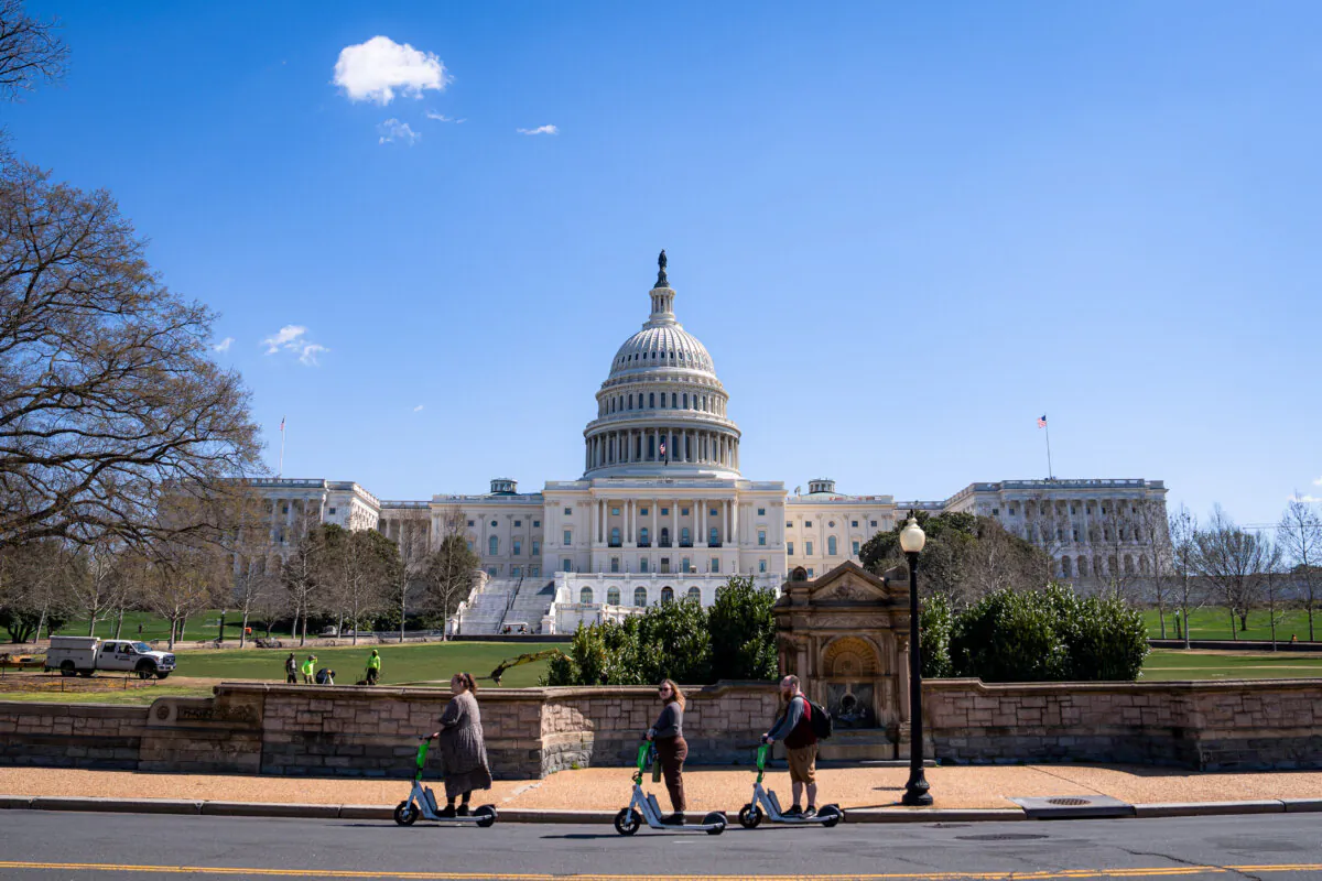 The U.S. Capitol building during cherry blossom in Washington on March 20, 2024. (Madalina Vasiliu/The Epoch Times)