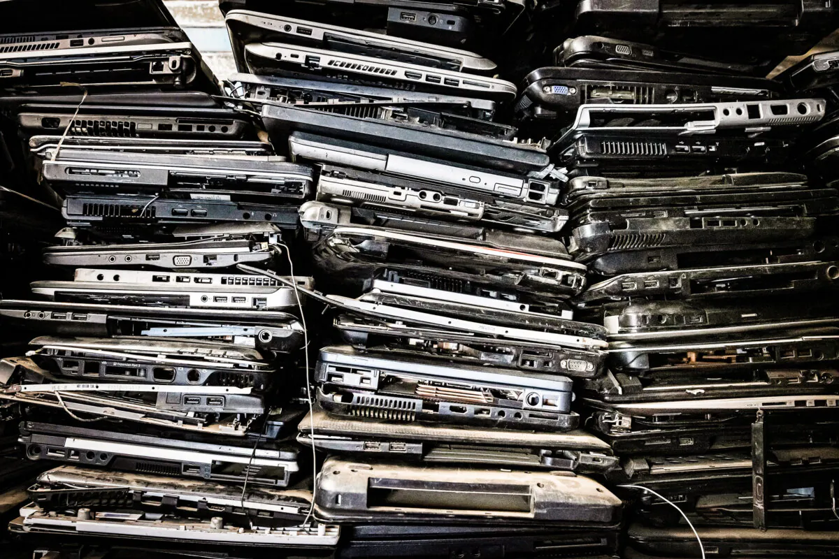 Old laptop casings are stacked on shelves in the local NGO Electronic Waste Initiative Kenya (E-WIK) workshop as the NGO collects electronic wastes to be processed, recycled, and repurposed in an informal settlement in Nairobi, Kenya, on Dec. 3, 2021. (ED RAM/AFP via Getty Images)