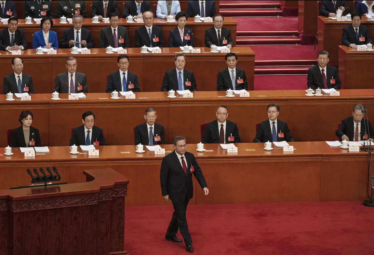 Chinese Premier Li Qiang (C) walks on the stage before his speech at the opening of the NPC, or National People's Congress, at the Great Hall of the People in Beijing, China on March 5, 2024. (Kevin Frayer/Getty Images)