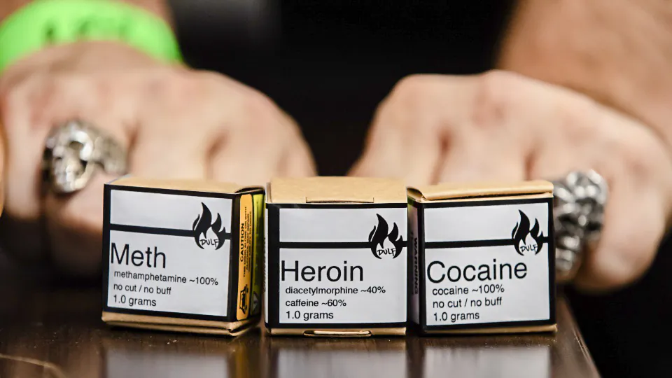 Methamphetamine, heroin, and cocaine from a safe supply being handed out to drug users to mark International Overdose Awareness Day, are displayed in the Downtown Eastside of Vancouver, on Aug. 31, 2021. (Darryl Dyck/The Canadian Press)