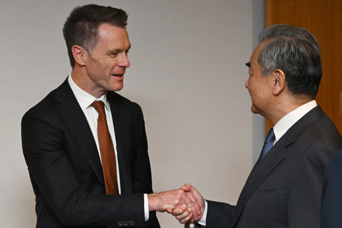 Beijing's Foreign Minister Wang Yi (R) shakes hands with New South Wales Premier Chris Minns during a visit to the New South Wales Parliament House in Sydney, Australia on March 21, 2024. (Dean Lewins/POOL/AFP via Getty Images)