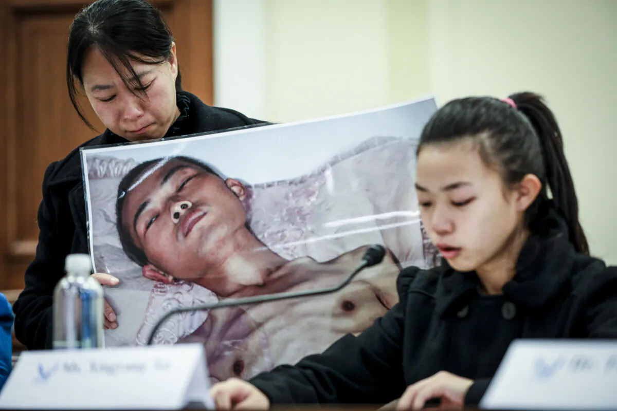 Xu Xinyang (R), a 17-year-old girl whose father (pictured) died as a result of the torture he endured in China because of his belief in Falun Gong, speaks at the "Deteriorating Human Rights and Tuidang Movement in China" forum, next to her mother Chi Lihua, at Congress in Washington on Dec. 4, 2018. (Samira Bouaou/The Epoch Times)
