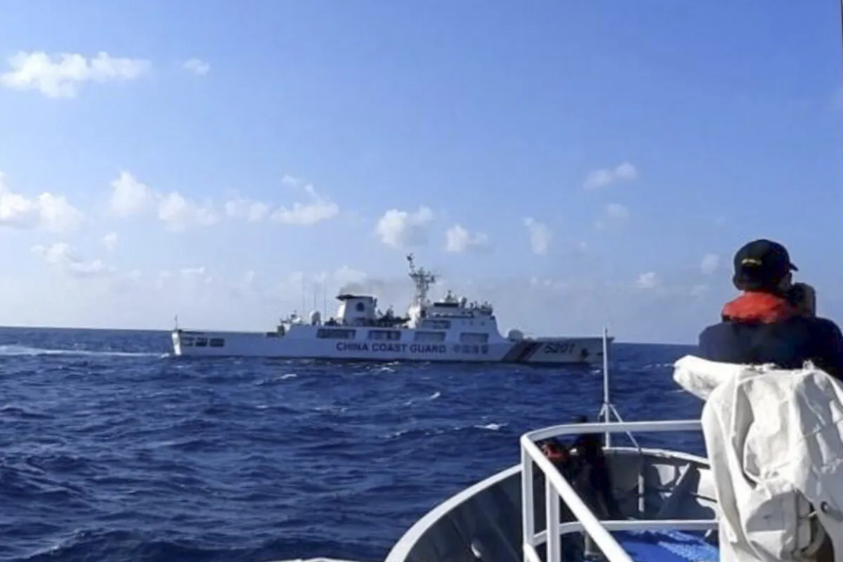 A Chinese coast guard ship (top) tries to block a Philippine government vessel at the disputed South China Sea on March 21, 2024. (Philippine Coast Guard via AP)