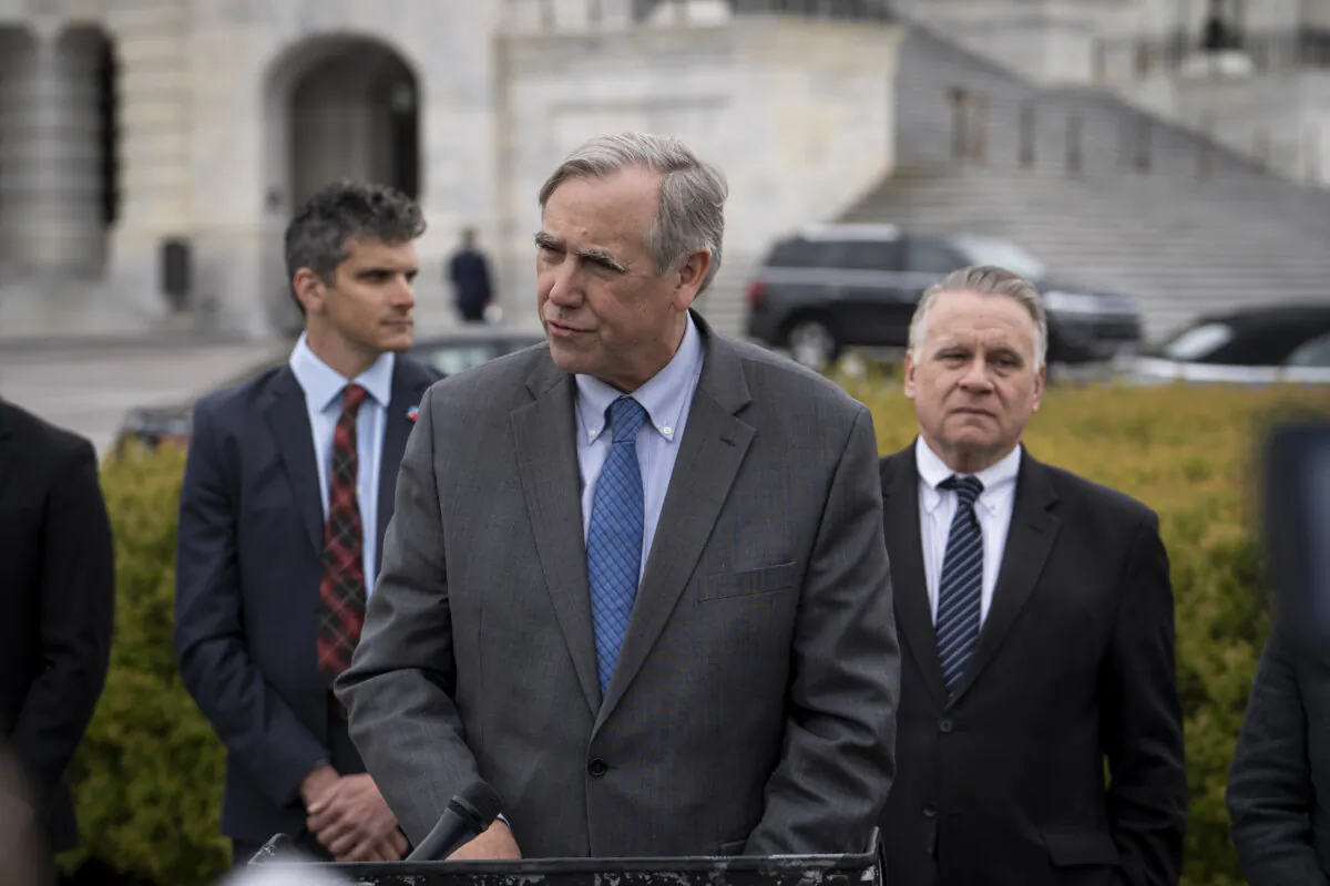 Sen. Jeff Merkley (D-Ore.) (L), joined by Rep. Chris Smith (R-N.J.) (R), chairman of the Congressional-Executive Commission on China, speaks during a news conference discussing the implications of the Safeguarding National Security Bill (Article 23 legislation) at the House Triangle near the U.S. Capitol on March 22, 2024. (Madalina Vasiliu/The Epoch Times)
