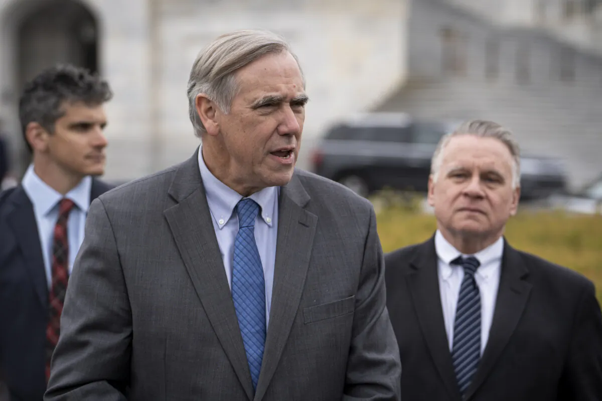 Sen. Jeff Merkley (D-Ore.) (C), joined by Congressional-Executive Commission on China (CECC) chair Rep. Chris Smith (R-N.J.) (R), speaks during a press conference in Washington on March 22, 2024. (Madalina Vasiliu/The Epoch Times)