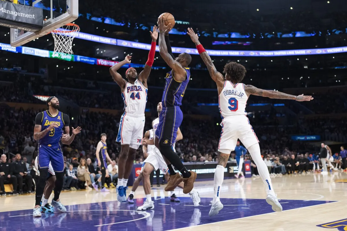 Los Angeles Lakers forward LeBron James (C) shoots against Philadelphia 76ers guard Kelly Oubre Jr. (R) and forward Paul Reed during the first half of an NBA basketball game in Los Angeles on March 22, 2024. (Jae C. Hong/AP Photo)