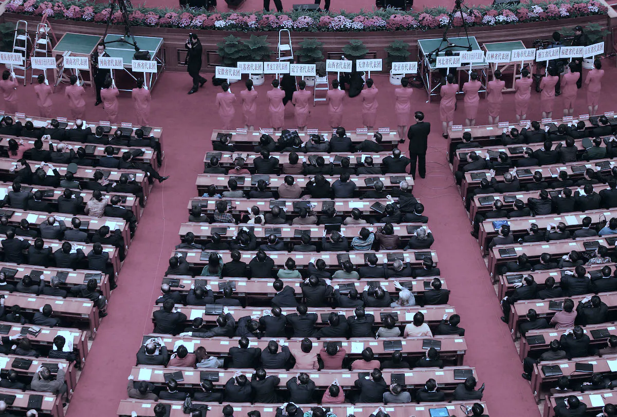 Attendants wait to lead delegates to small group discussions of the draft of the anti-secession law during the second plenary session of the National People's Congress, or parliament, on March 8, 2005 in Beijing, China. (Cancan Chu/Getty Images)