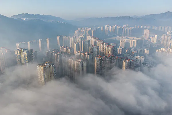 Guizhou Province ranks among the top in debt levels in China. The image shows a cluster of buildings shrouded in morning fog in Bijie City, China's southwestern Guizhou Province, on Nov. 18, 2021. (STR/AFP via Getty Images)