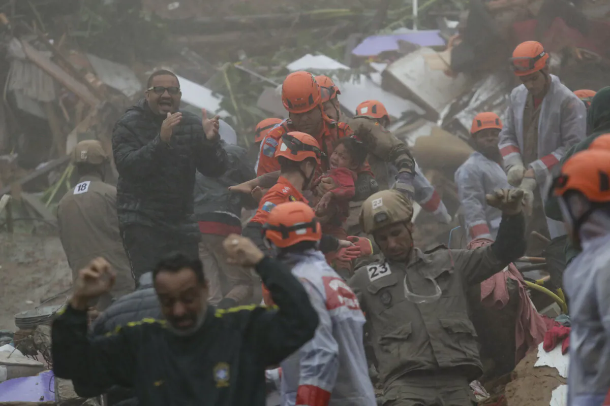 Emergency personnel carry a 4-year-old girl who was rescued from her collapsed house after heavy rains, in Petropolis, Rio de Janeiro state, Brazil, Saturday, March 23, 2024. (AP Photo/Bruna Prado)