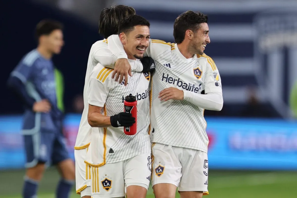 LA Galaxy midfielder Mark Delgado (8) and midfielder Gaston Brugman (5) celebrate after a Galaxy goal against Sporting Kansas City during the second half in Kansas City on March 23, 2024. (William Purnell/USA TODAY Sports via Field Level Media)