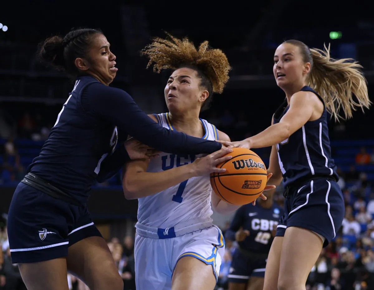 Kiki Rice (1) of the UCLA Bruins drives to the basket between Anaiyah Tu'ua (15) and Nhug Bosch Duran (4) of the California Baptist Lancers during the first half of the NCAA Women's Basketball Tournament—First Round at UCLA Pauley Pavilion in Los Angeles on March 23, 2024.  (Harry How/Getty Images)