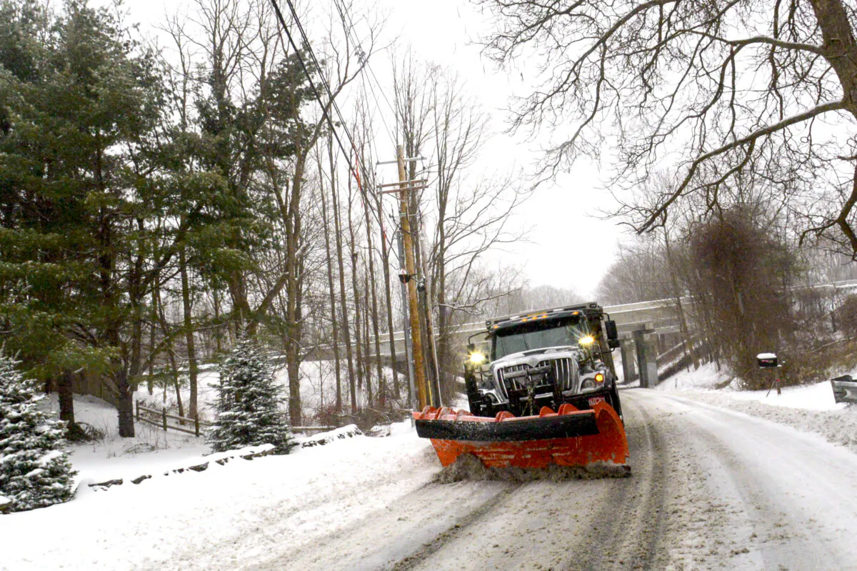 A snowplow removes the snow on Maple Street in Brattleboro, Vt., on March 23, 2024. (Kristopher Radder/The Brattleboro Reformer via AP)