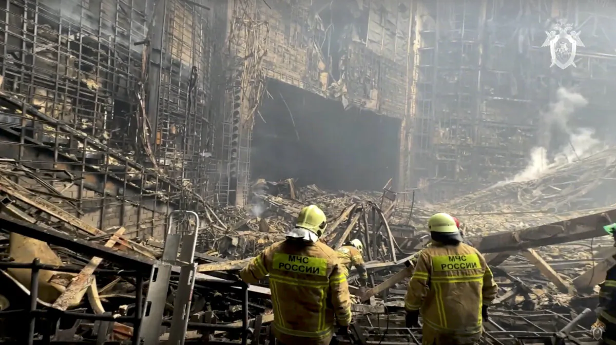 Firefighter work in the burned concert hall after an attack on the building of the Crocus City Hall on the western edge of Moscow, Russia, on March 23, 2024, in a still from video. (Investigative Committee of Russia via AP)