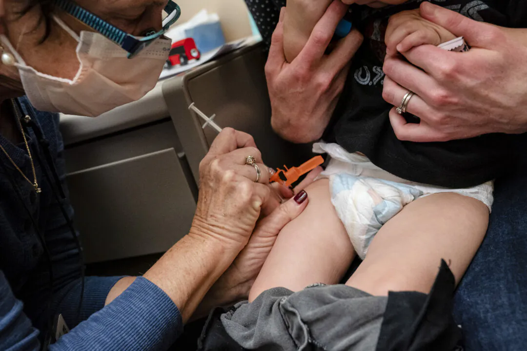 A 1-year-old child receives a Pfizer COVID-19 vaccination in Seattle, Wash., on June 21, 2022. (David Ryder/Getty Images)