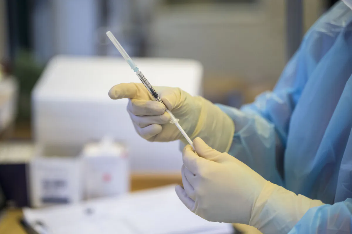 A healthcare worker prepares a COVID-19 vaccine in a file image. (Thomas Lohnes/Getty Images)