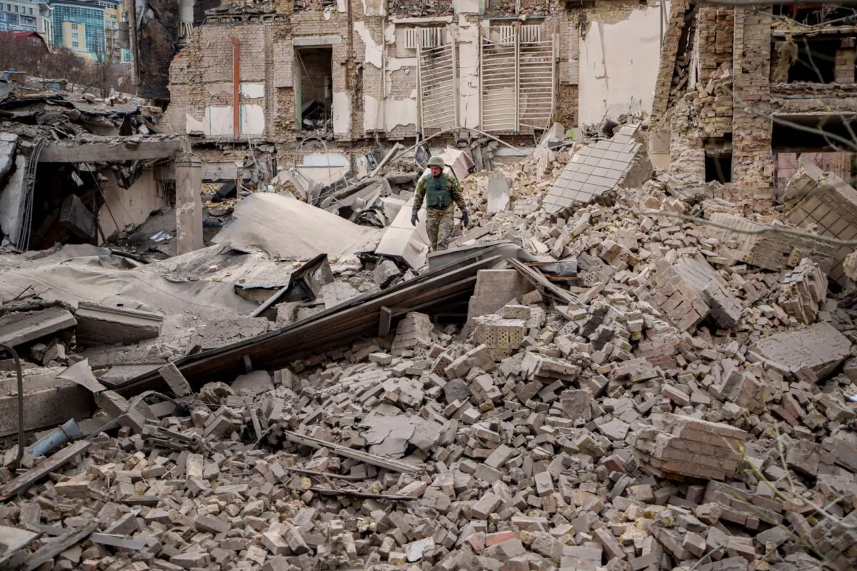 A Ukrainian serviceman inspects the damage to a building at the Pecherskyi district, after a Russian air attack in Kyiv, Ukraine, on March 25, 2024. (Vadim Ghirda/AP Photo)